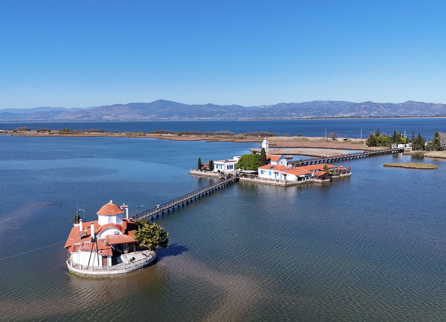 Scenic aerial view of Aghios Nikolaos Monastery on a lake in Yunanistan.