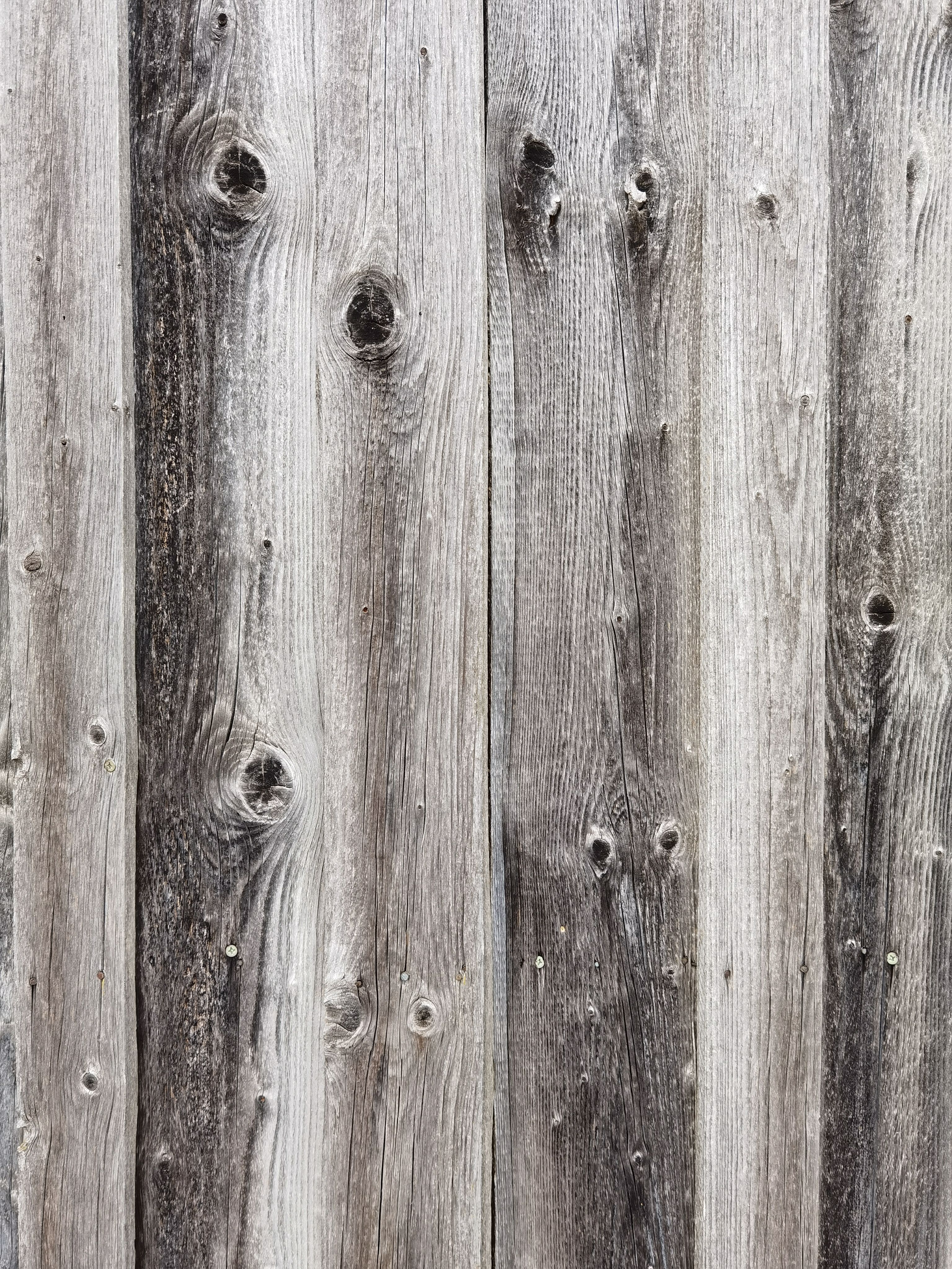 Weathered grey wood planks showing the effects of moisture and UV exposure over time