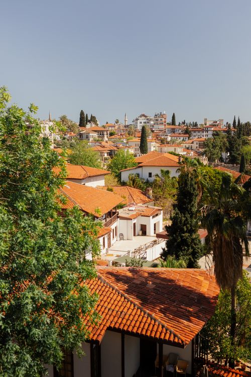 Free Enjoy a sunny cityscape view of traditional rooftops in Antalya, Türkiye. Stock Photo