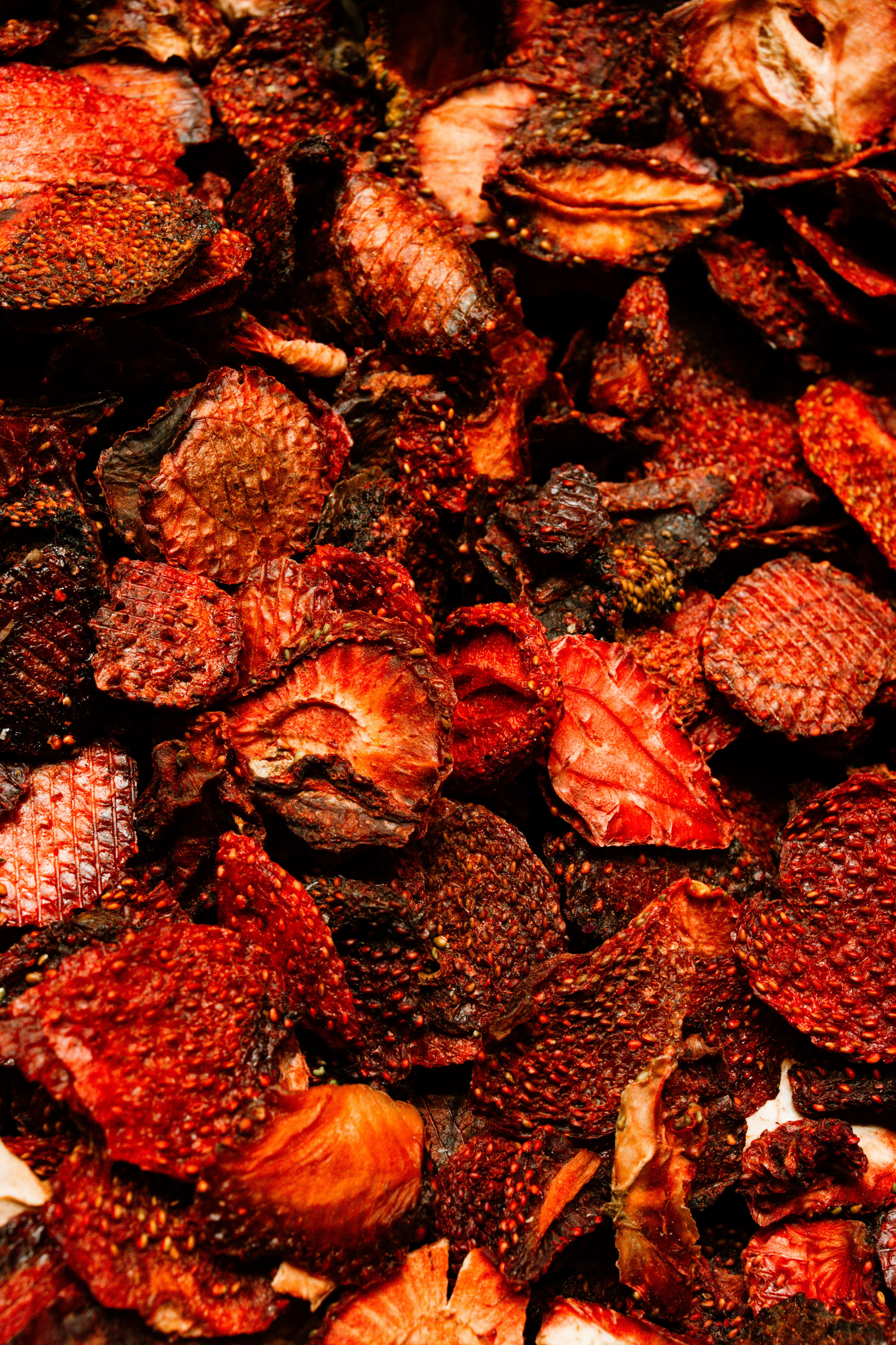 Vivid collection of dried fruits displaying rich textures and deep colors.
