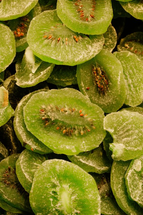 Free Vibrant close-up of green dried kiwi slices showcasing texture and color. Stock Photo