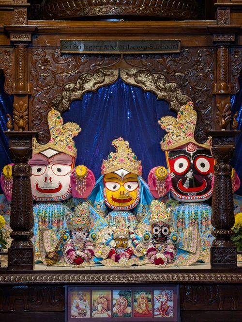 Free Colorful Jagannath deity figures adorned with flowers and textiles, Toronto temple. Stock Photo