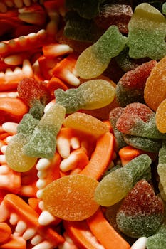 Vibrant variety of gummy candies including teeth shapes and sour gummies.