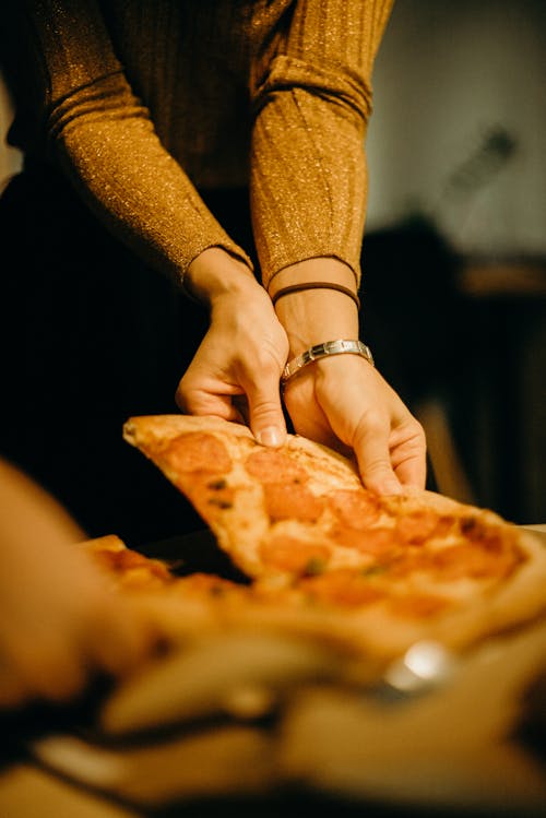 Woman Picking Pizza