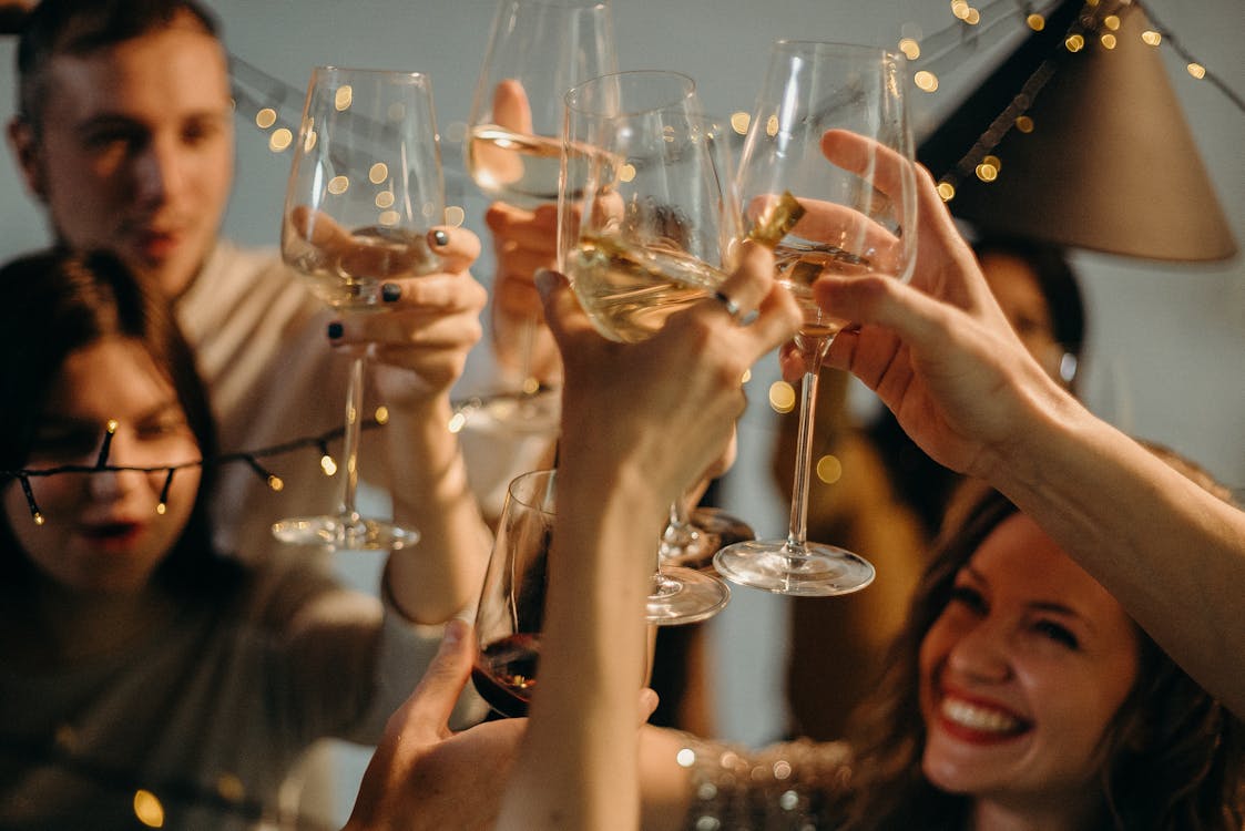 Group of friends toasting and clinking drinks