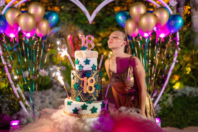 Birthday Woman Blowing Candles On Cake During Celebration