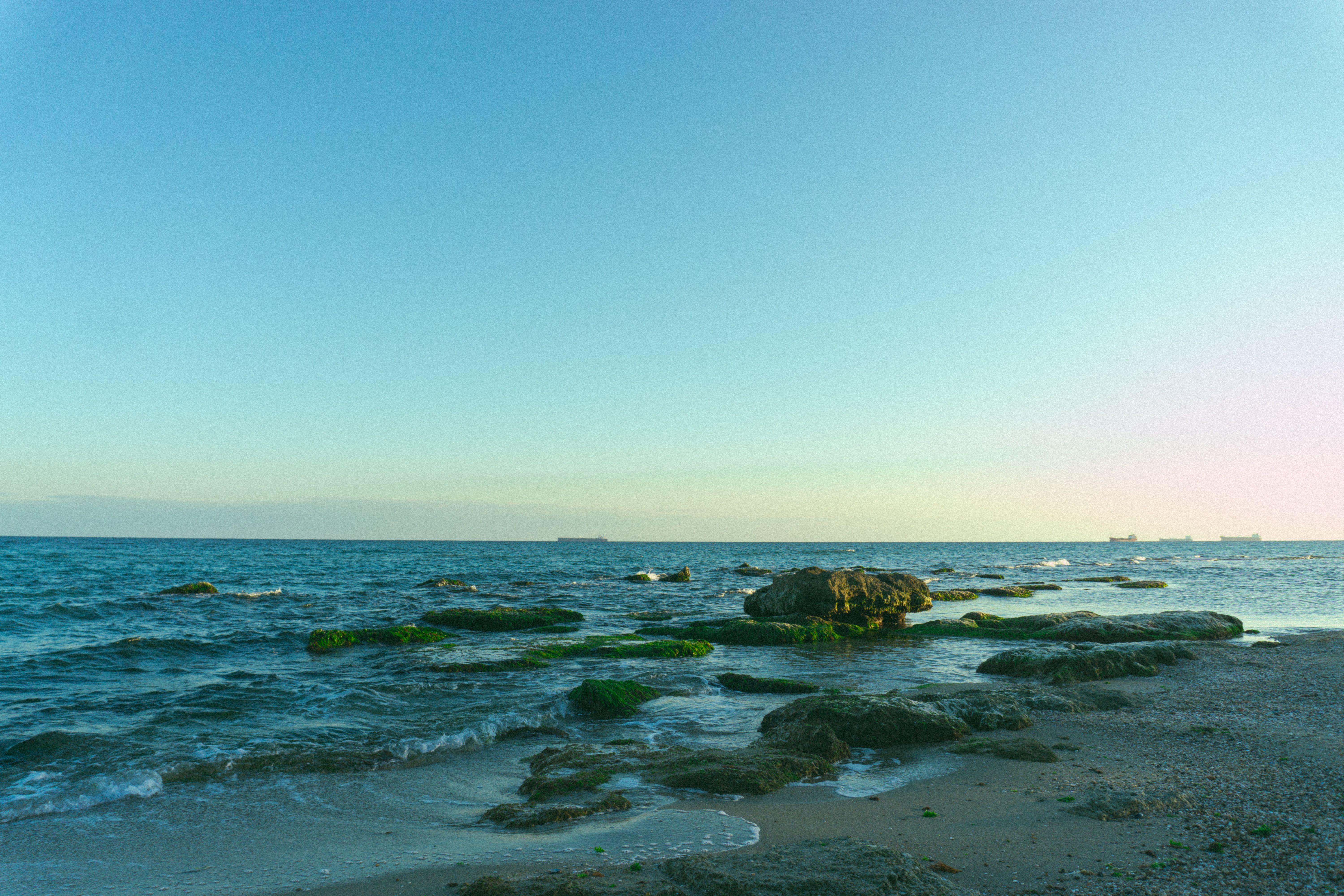 Scenic View of Rocky Beach and Blue Sea · Free Stock Photo