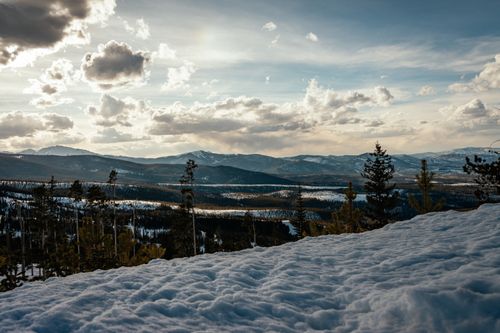 Free Scenic view of snow-covered mountains and cloudy sky during daytime, capturing the beauty of winter landscape. Stock Photo