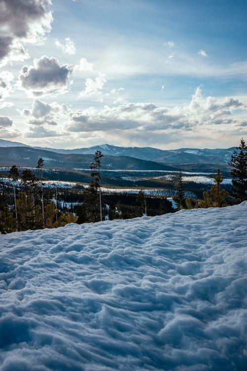 Free Peaceful winter landscape with snow and mountains under a cloudy sky. Stock Photo
