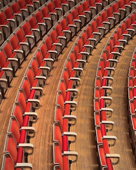 Abstract view of rows of red seating in the Sydney Opera House, showcasing geometric patterns and comfort.