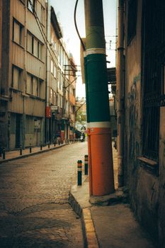 Vibrant pole on a deserted street in Bursa, Türkiye, evoking an urban vibe.