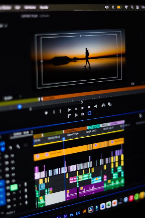 A Man Sitting on Front of the Computer while Editing Video · Free Stock ...