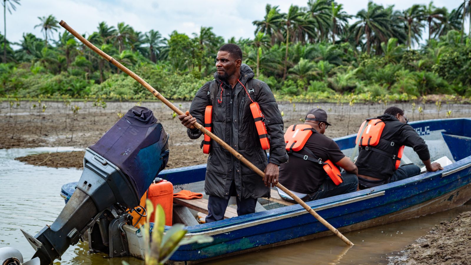 Fishermen navigating river in port harcourt nigeria