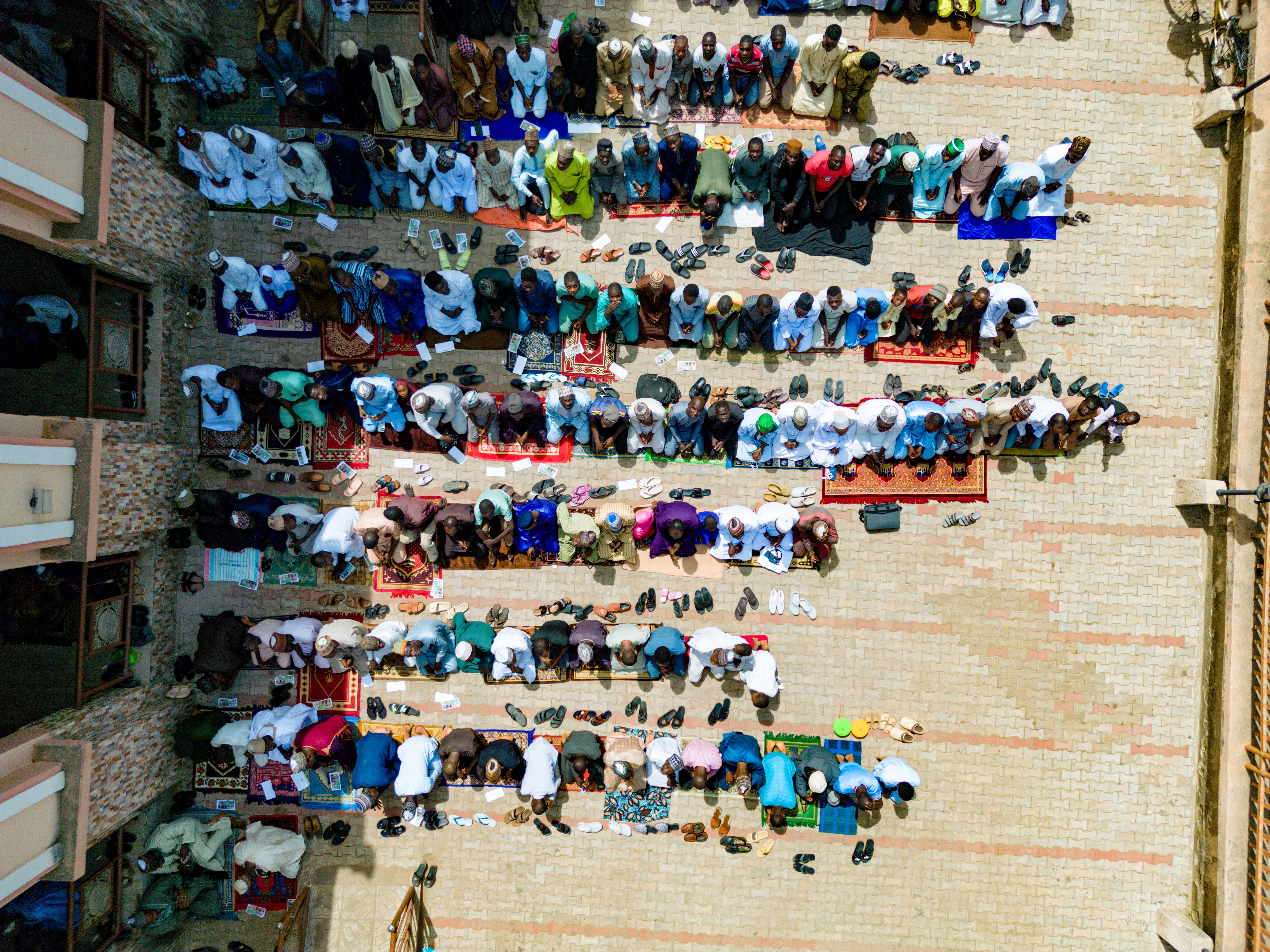 Aerial view of Christ Embassy Loveworld Arena courtyard filled with young people eating at communal tables