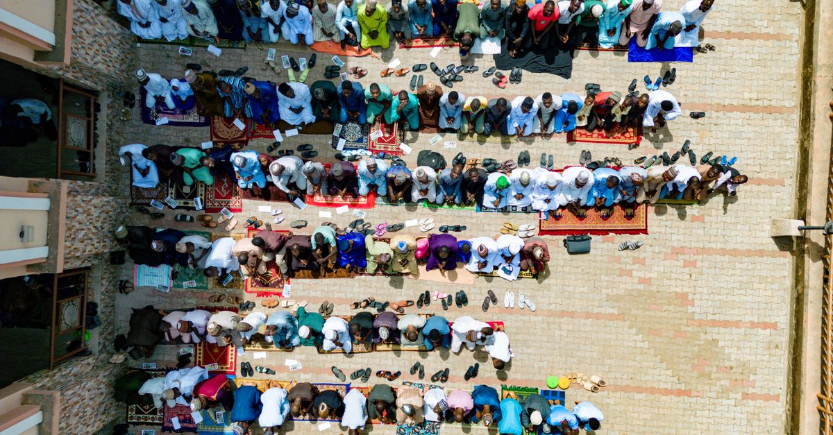 Aerial view of Christ Embassy Loveworld Arena courtyard filled with young people eating at communal tables