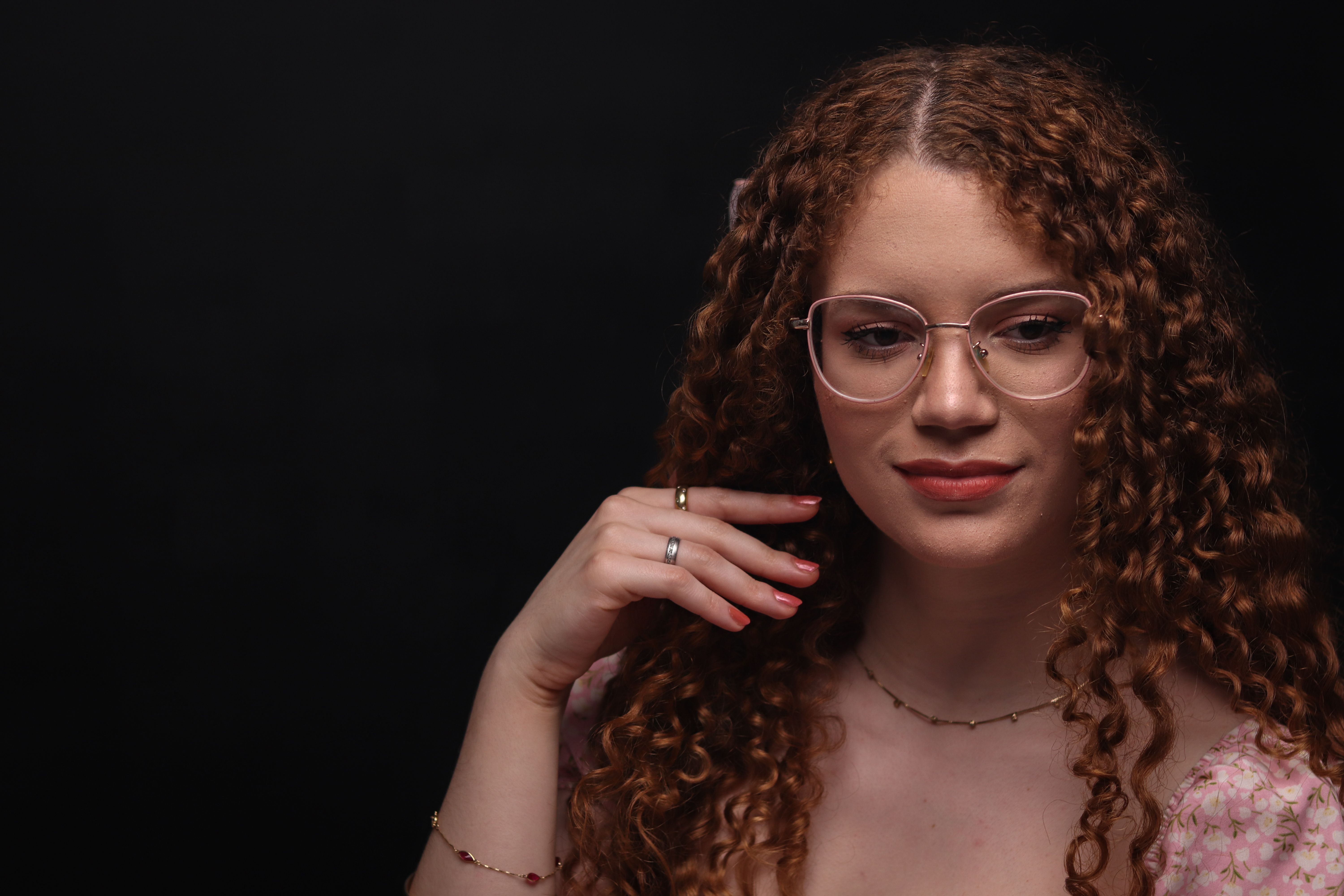 Portrait of Woman with Curly Hair and Glasses · Free Stock Photo