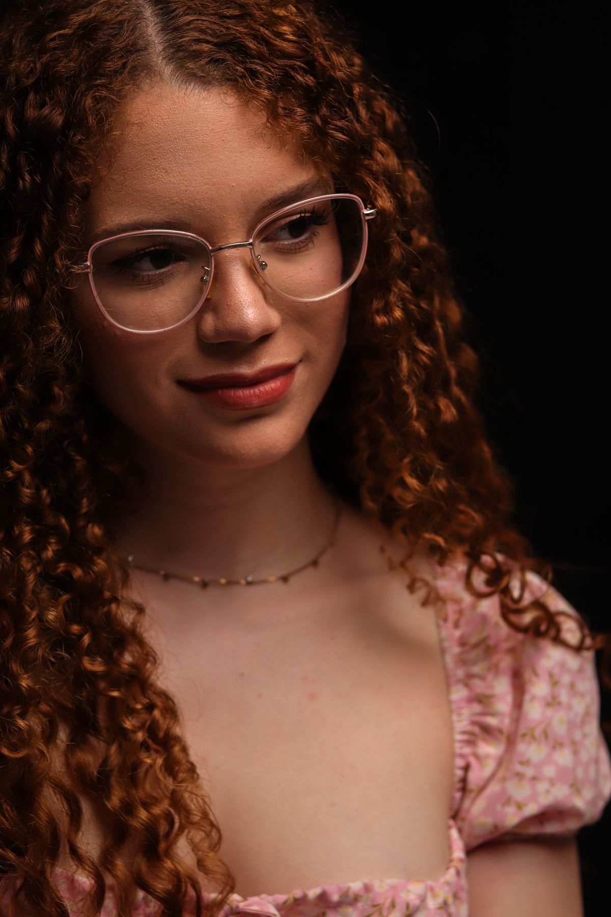 Portrait of a Woman with Curly Hair and Glasses · Free Stock Photo