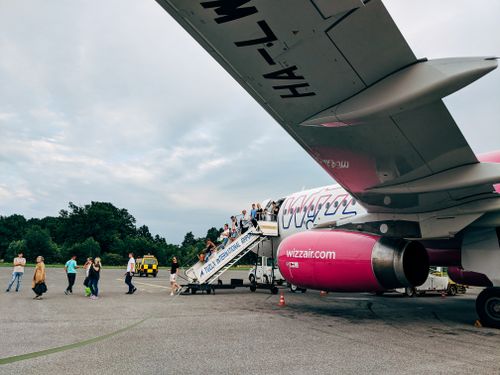 Free A vibrant scene of passengers boarding a Wizzair flight at Tuzla International Airport, Bosnia. Stock Photo