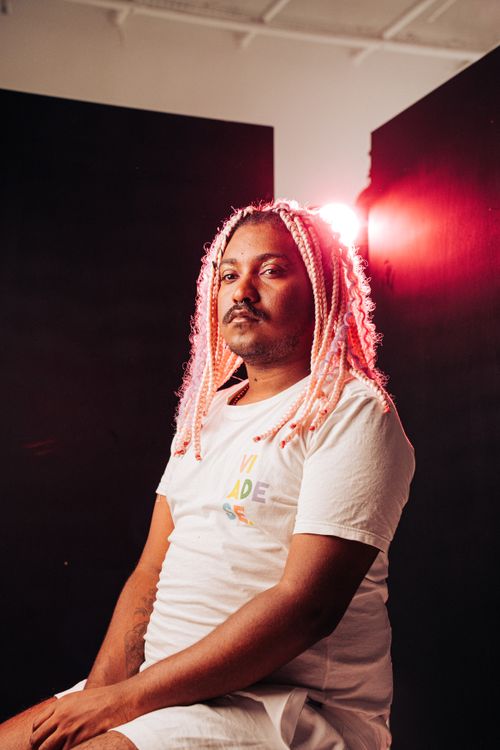 Free Captivating studio portrait of an adult wearing pink braided hair, showcasing unique style. Stock Photo