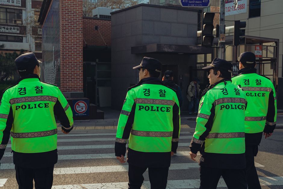 Police officers on duty in Seoul, South Korea, showcasing urban life and safety enforcement.