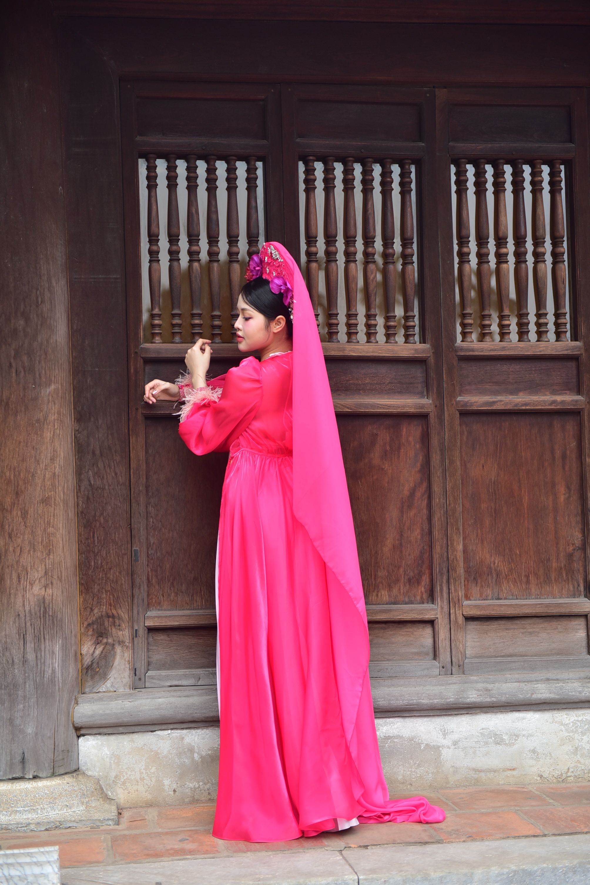 Woman in Traditional Pink Dress by Wooden Doorway · Free Stock Photo