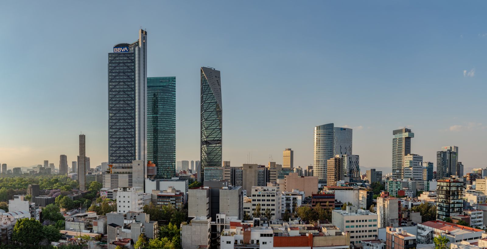 Mexico City skyline with Torre BBVA and Torre Reforma at sunset.