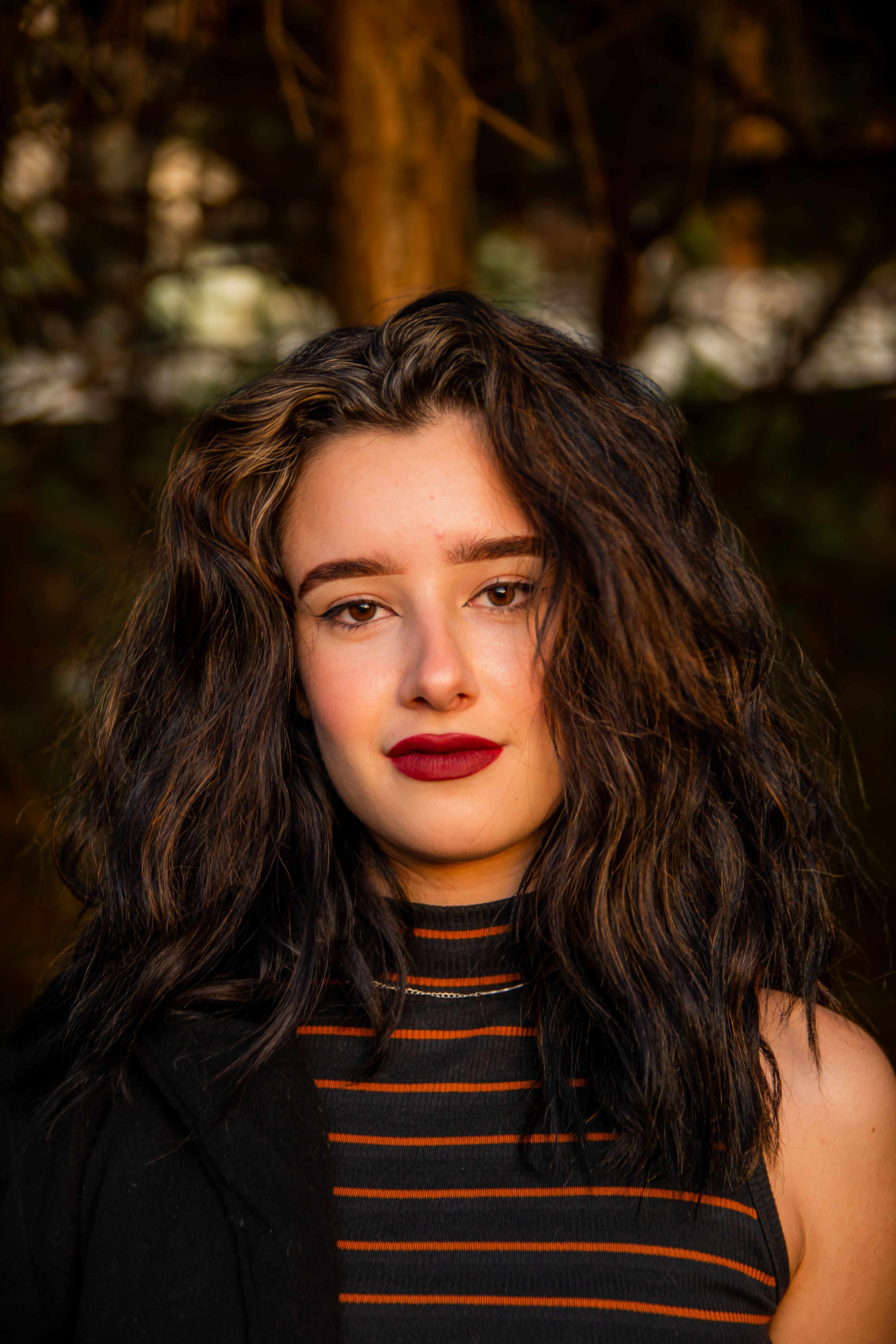 Portrait of Young Woman with Wavy Hair · Free Stock Photo
