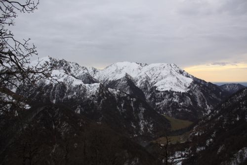 Free Breathtaking view of a snow-covered mountain range under a pastel sky at sunrise. Stock Photo