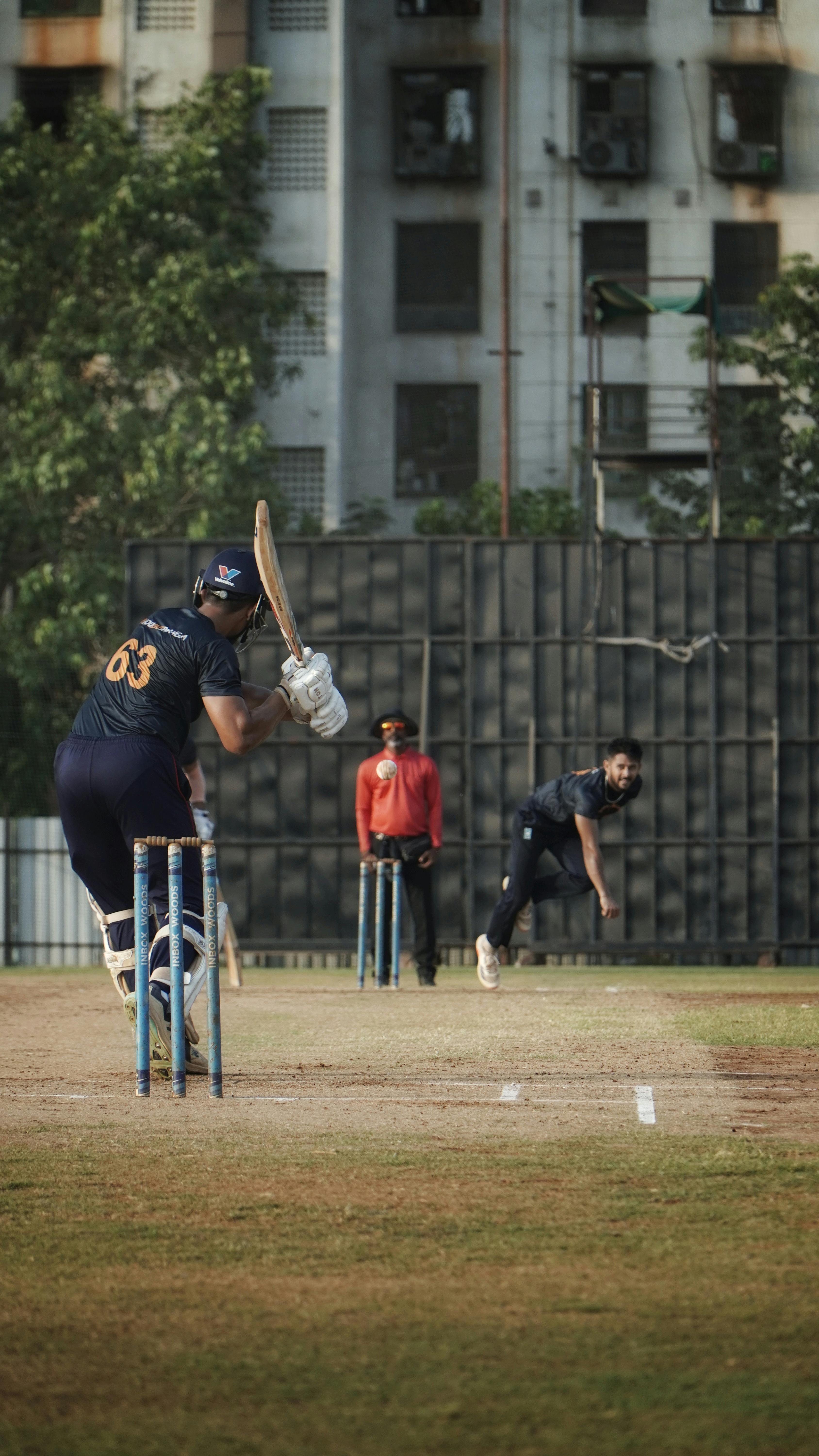 Exciting cricket match moment in Mumbai showcasing players in full action on a vibrant sunny day.