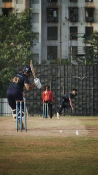 Exciting cricket match moment in Mumbai showcasing players in full action on a vibrant sunny day.