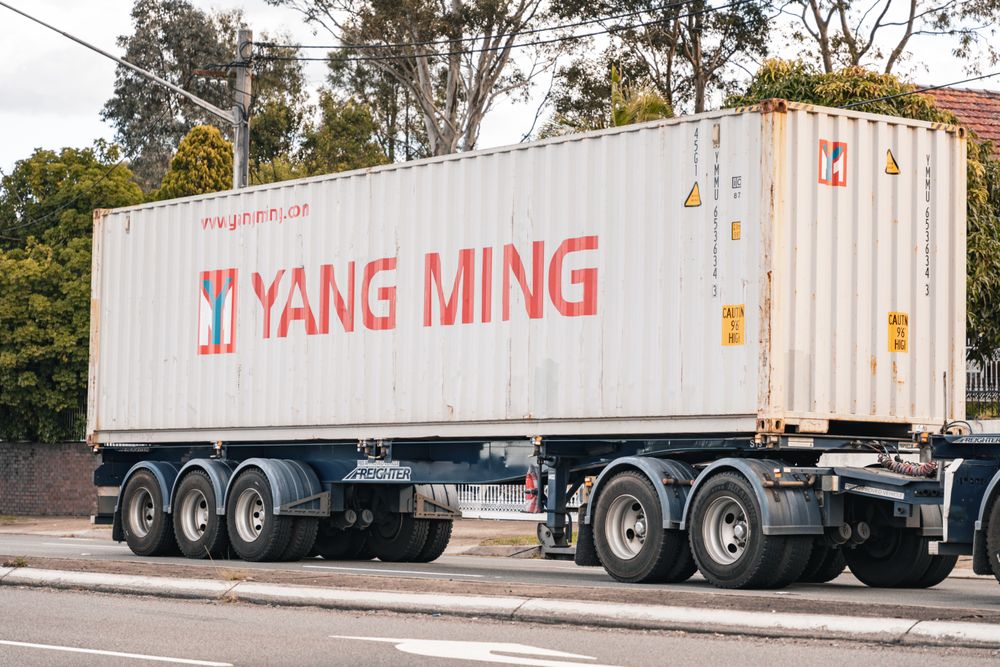 Skeleton container chassis trailer carrying a shipping container