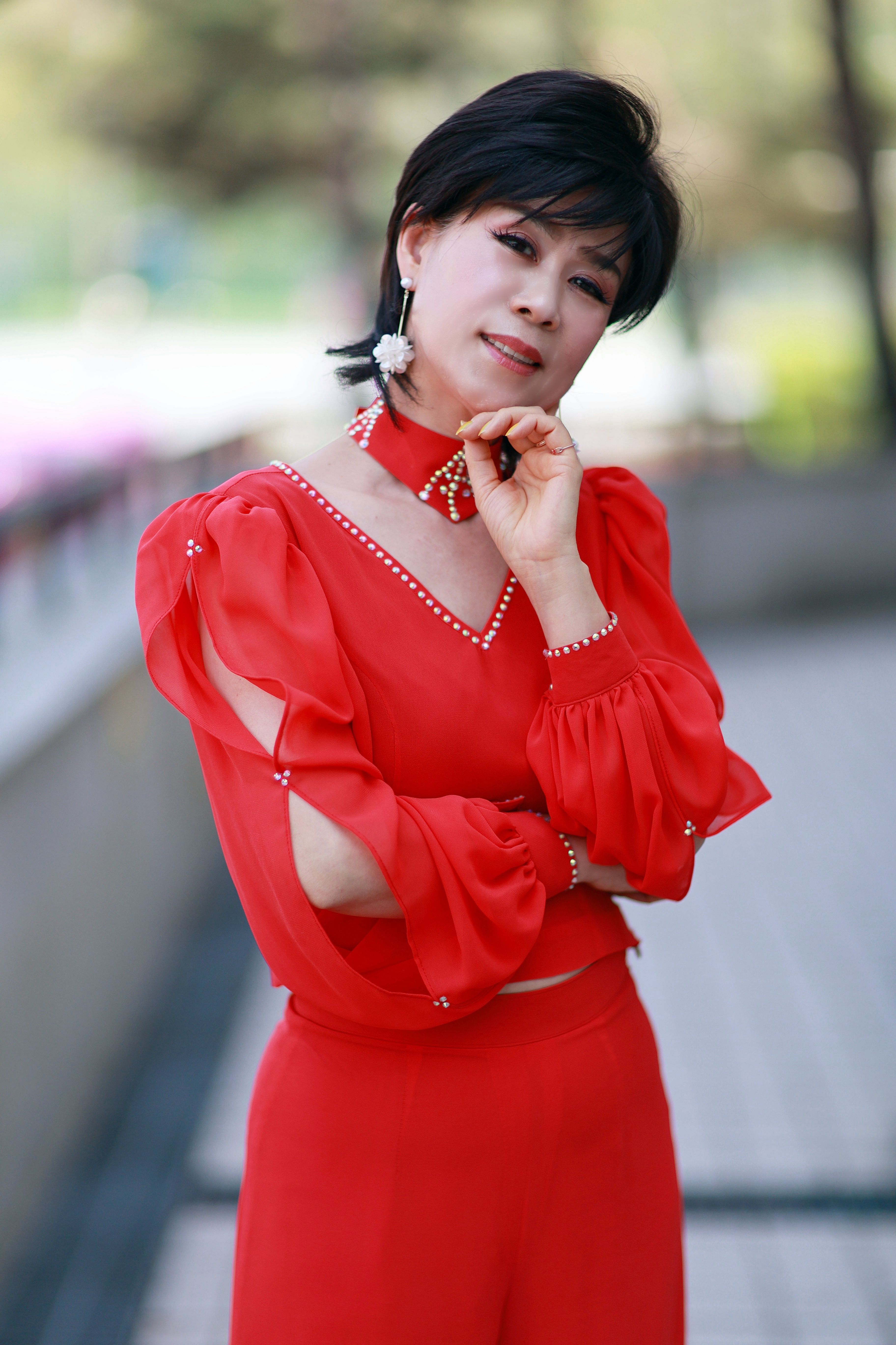 Elegant Woman Posing in Stylish Red Outfit Outdoors · Free Stock Photo