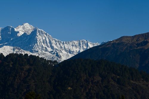 Free Capture of the snow-capped Himalayan peaks against a clear blue sky. Stock Photo