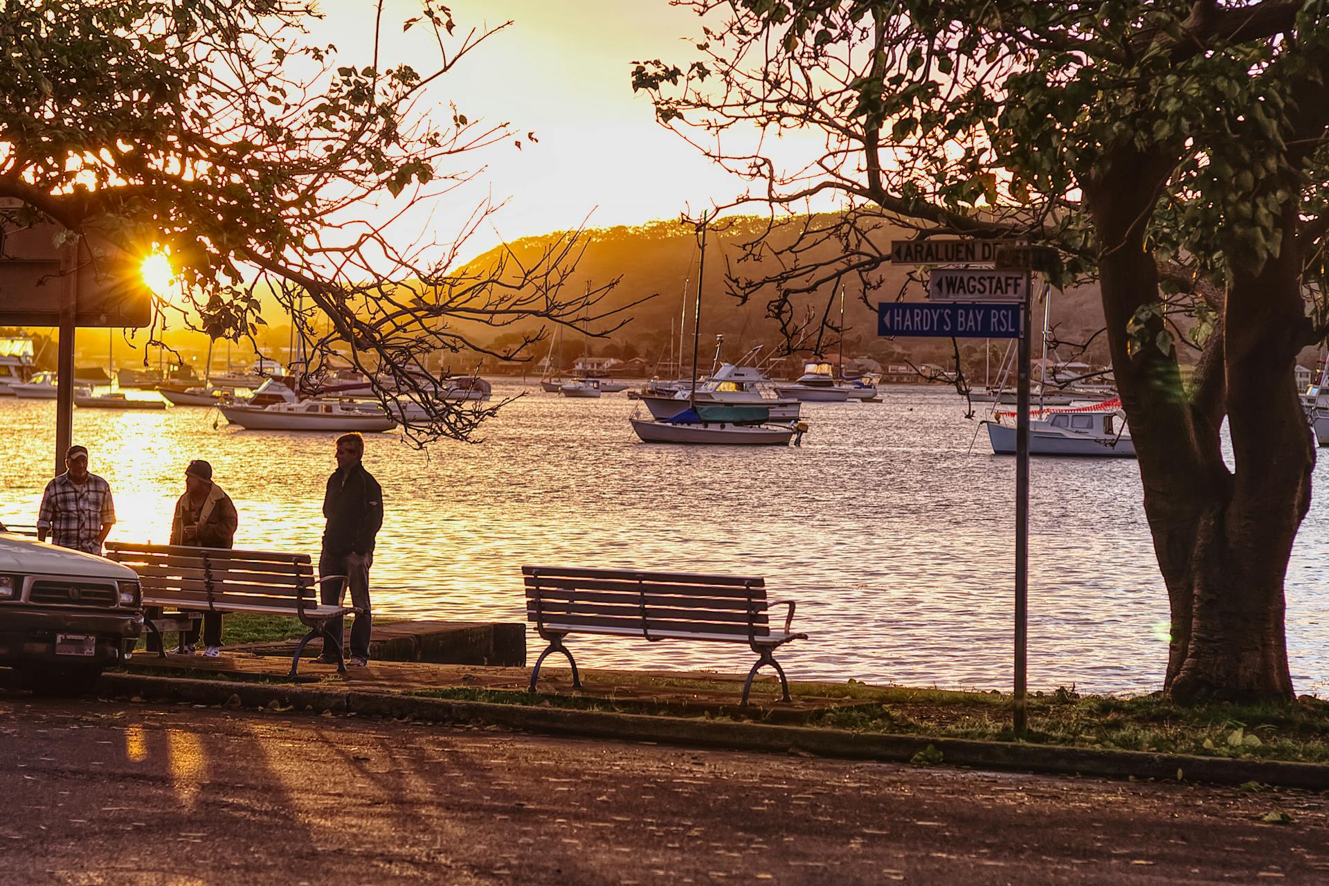 Serene sunset view at Wagstaff Foreshore, featuring docked boats, benches, and a tranquil ambience.