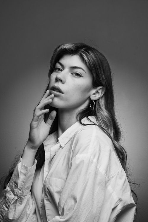Free A striking black and white portrait of a woman posing gracefully with a thoughtful expression. Stock Photo