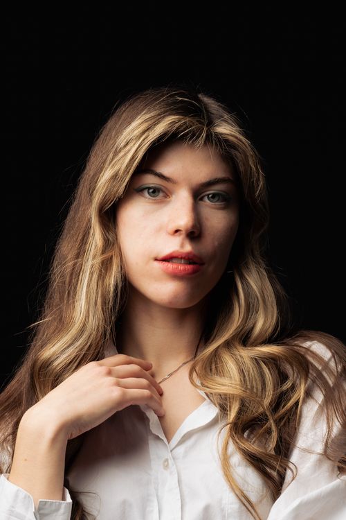 Free Sophisticated portrait of a young woman in a white shirt, showcasing natural beauty. Stock Photo