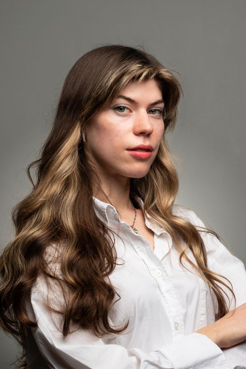 Free Professional studio portrait of a confident woman in a white shirt, exuding elegance and poise. Stock Photo