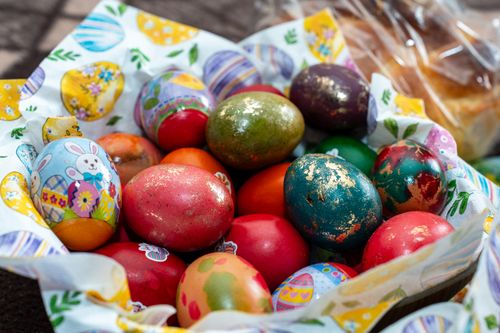 Free Colorful Easter eggs in a decorative basket perfect for holiday celebrations. Stock Photo