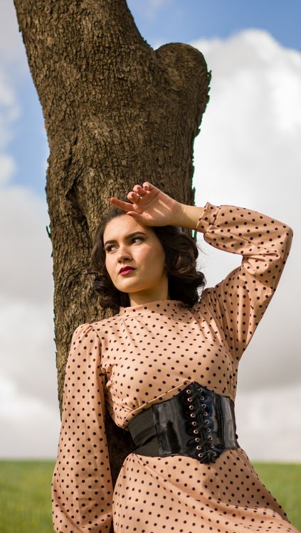Woman in Polka Dot Dress Relaxing by Tree · Free Stock Photo