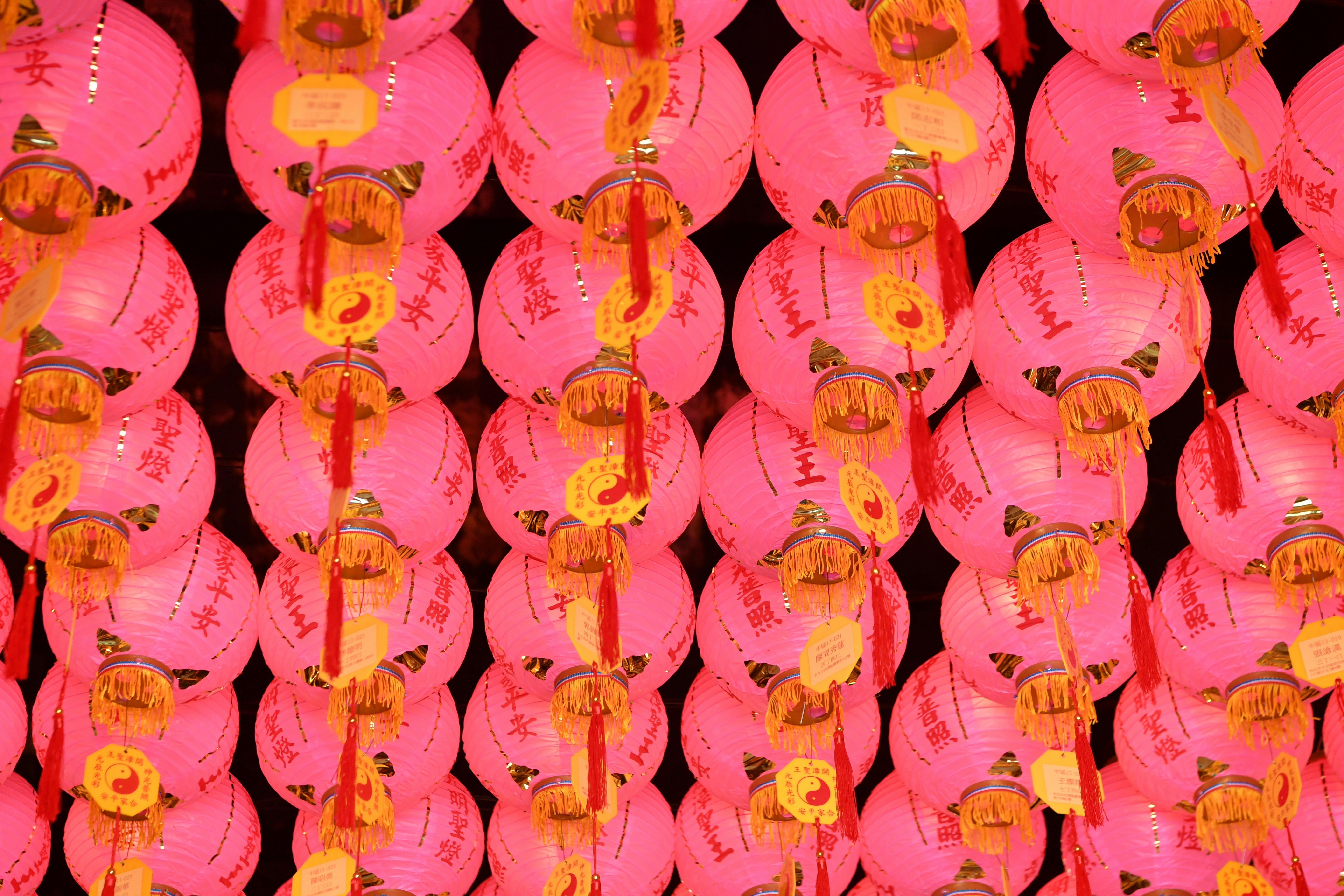Rows of pink lanterns with red tassels creating a vibrant and festive atmosphere.