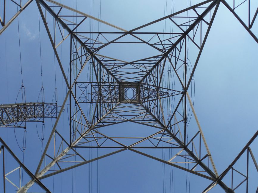 Supply Chain Cybersecurity For Architecture And Energy Firms 4 - Supply Chain Cybersecurity,Cybersecurity Best Practices For Small Architecture And Energy Firms - - Bonelli Systems A Striking Low Angle Perspective Of An Electricity Tower With A Clear Blue Sky Background.