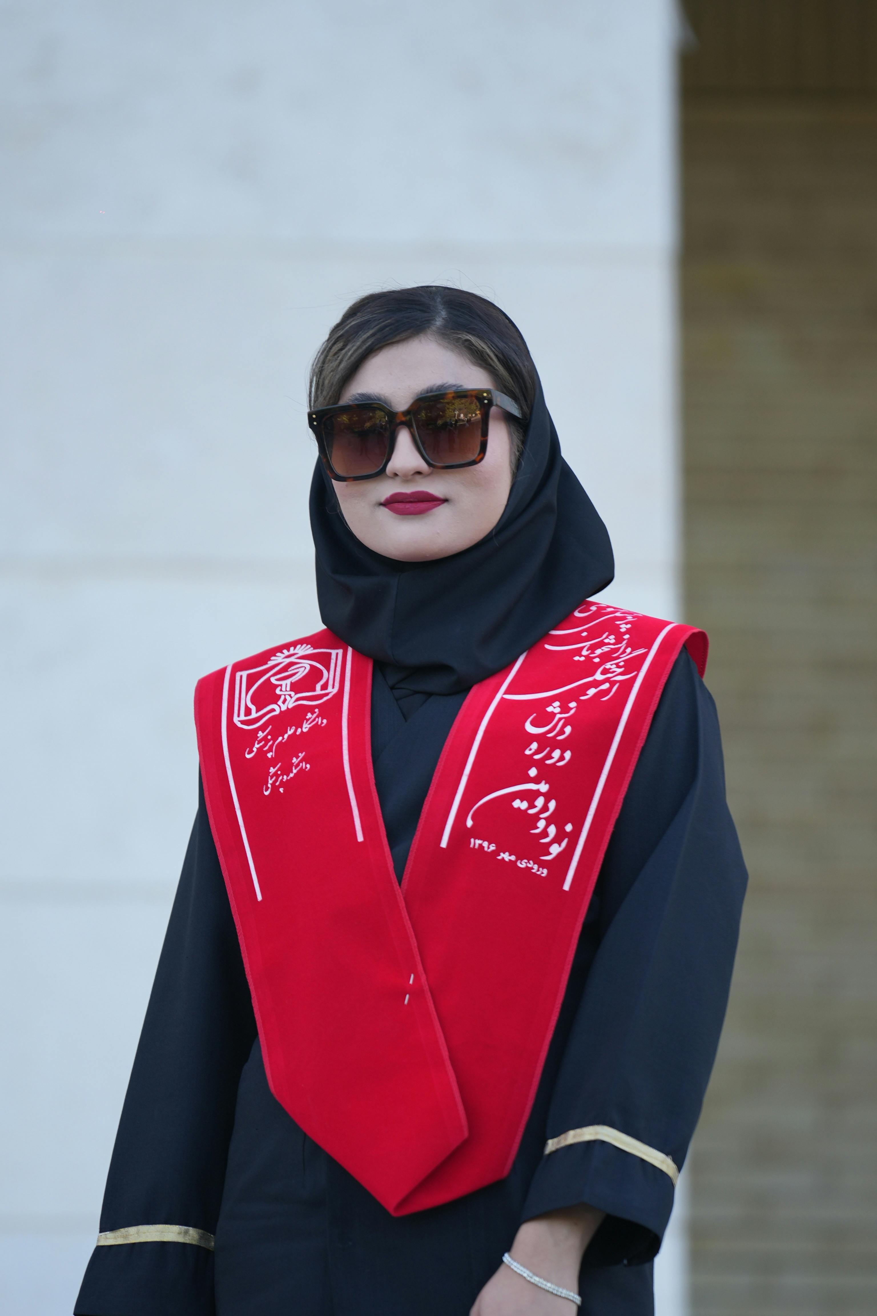 iranian graduate in traditional hijab and red stole