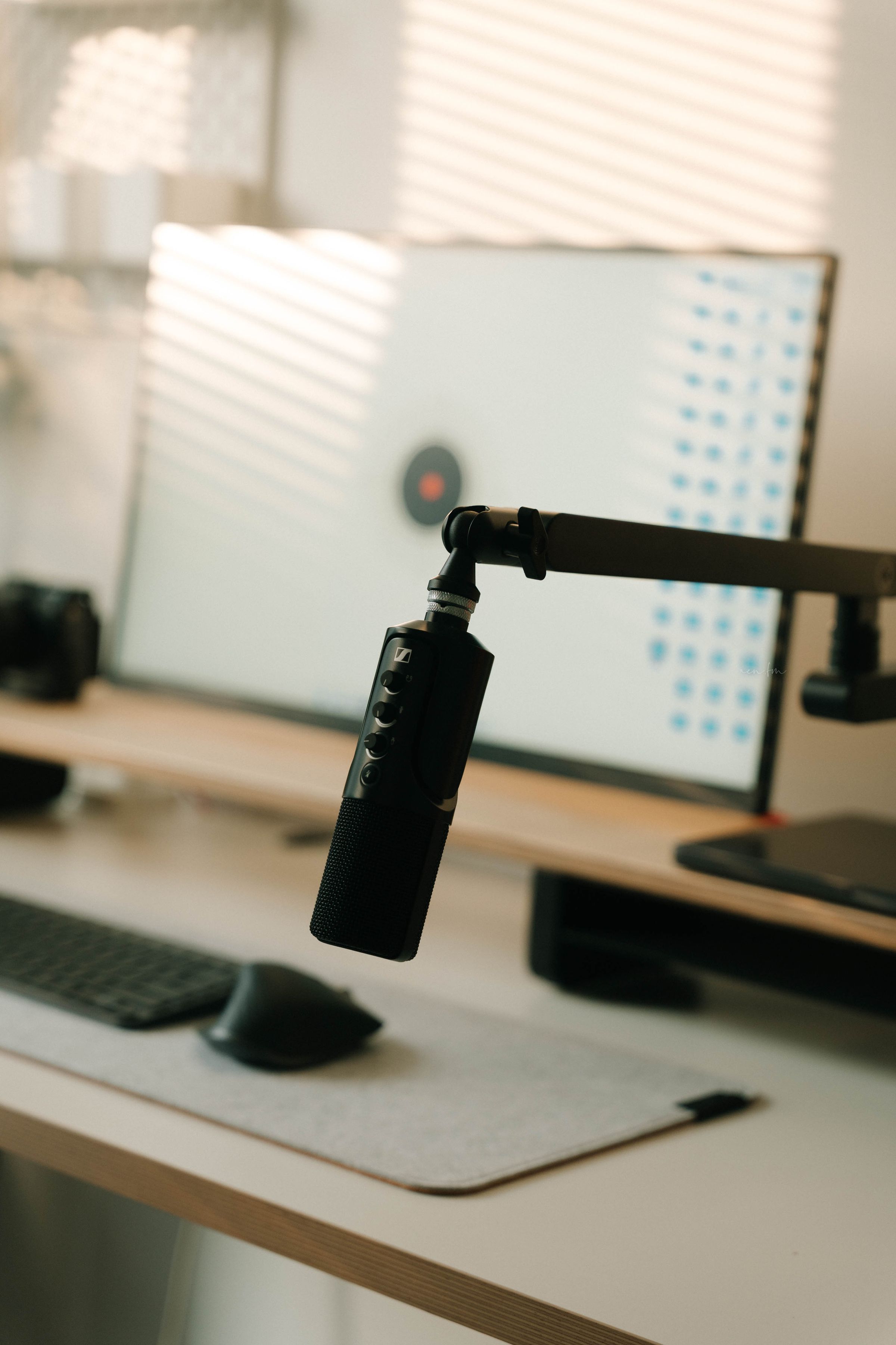 Mounted microphone beside a modern computer gaming setup