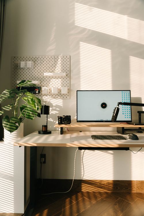 Free A modern home office with a clean desk setup, natural lighting, and stylish decor. Stock Photo