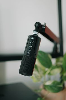 Close-up of a black microphone on a stand, perfect for recording and broadcasting.