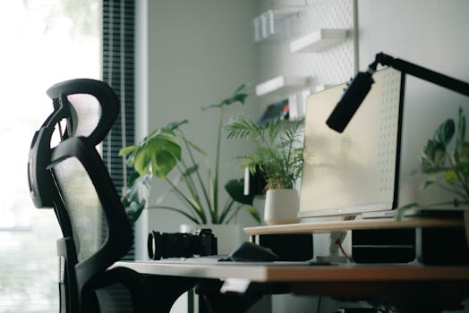 A stylish home office featuring an ergonomic chair, computer setup, and indoor plants, ideal for work inspiration.