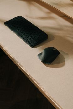 Close-up of a sleek keyboard and mouse on a modern desk, perfect for a minimalist workspace.