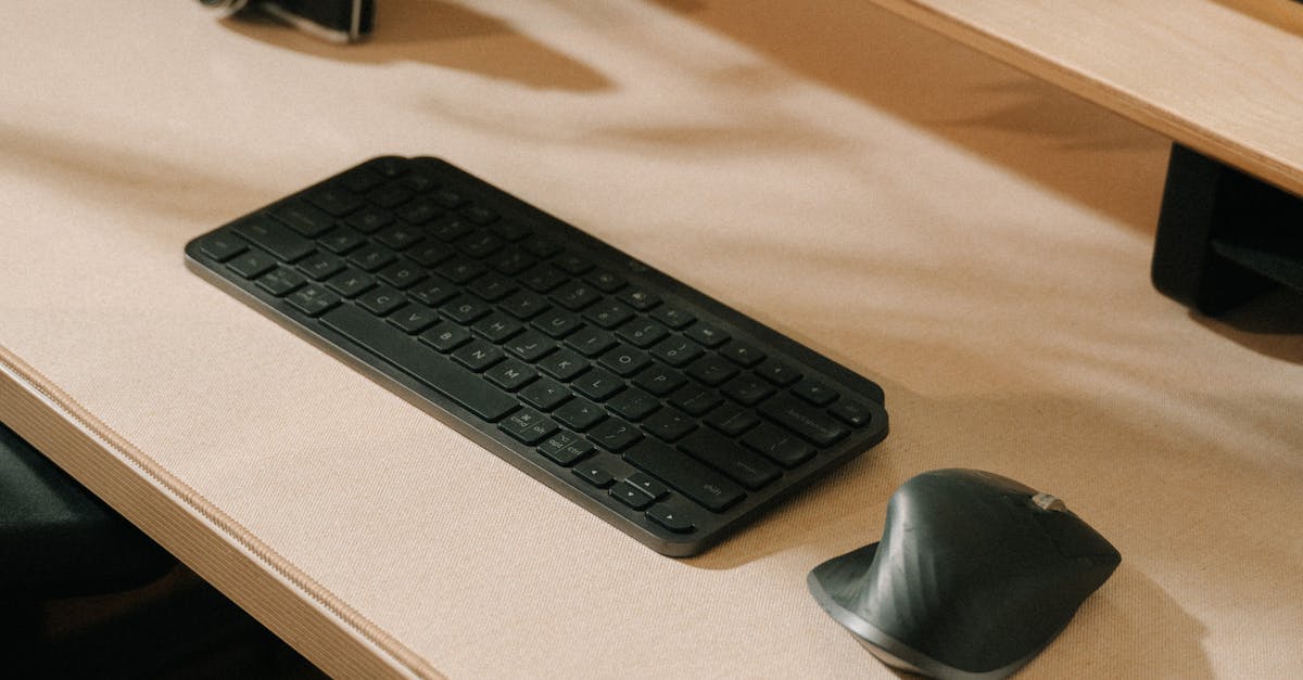 A minimalist desk setup featuring a keyboard, mouse, and a vintage camera under soft lighting.
