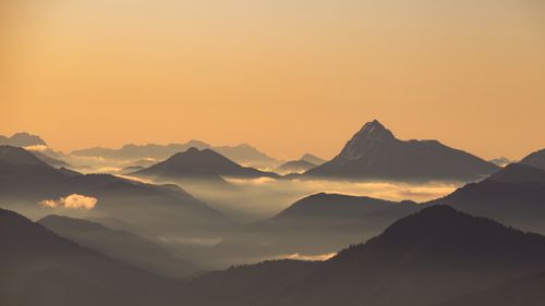 Free Explore the stunning Ohlstadt mountains in Bavaria, Germany, captured at sunrise with a mystical fog. Stock Photo