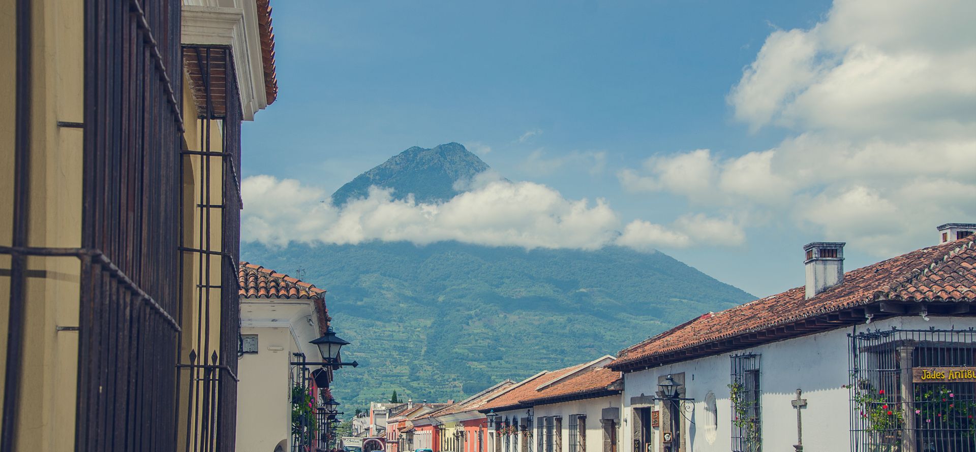 Edificios coloniales de Antigua Guatemala con volcán al fondo